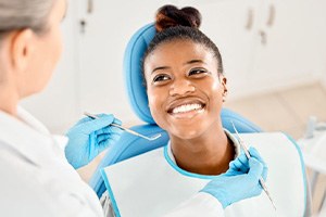Patient smiling at her dental care provider