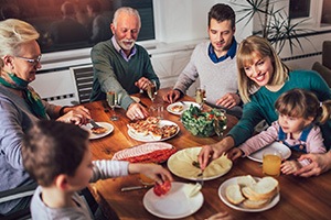 Family sharing a meal together at dining room table