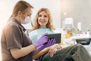 Dental team member assisting patient at front desk