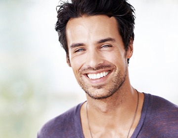 Man smiling in purple tee shirt