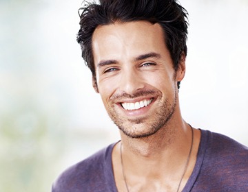 Man smiling after visiting his dentist