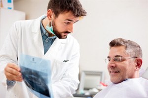 Dentist and patient discussing the need for root canal therapy