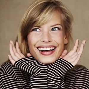 Woman showing off smile after cosmetic dentistry