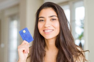 Smiling woman holding payment card