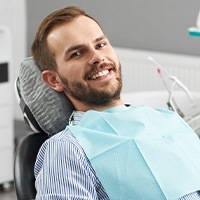 Man smiling during second dental crown visit