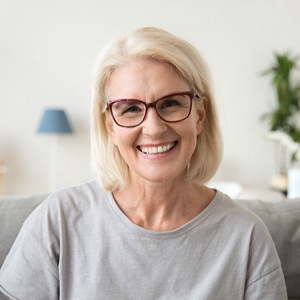 Happy senior woman in gray shirt with dentures in Westborough