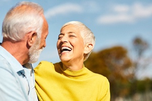 Senior man and woman with dentures, laughing outdoors