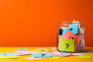 Jar filled with cards marked with question marks