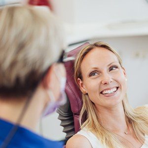 Woman smiling during emergency dentistry visit