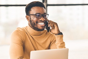 Smiling man calling for emergency dentistry