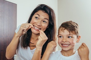 Mother and child flossing to prevent dental emergencies