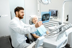 Dentist and patient discussing candidacy for full mouth reconstruction