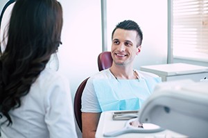 Happy dental patient learning about dental implants in Westborough