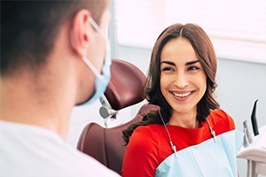 Woman smiling after dental implant placement