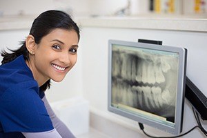 Dental team member looking at digital x-rays
