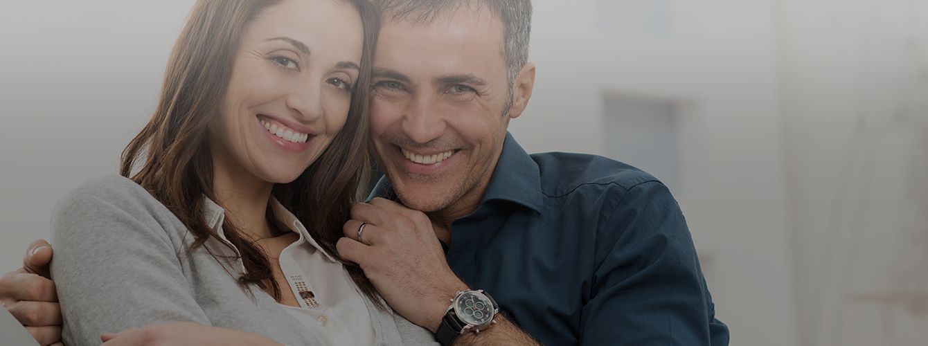 Man and woman smiling after visiting their dentist in Westborough