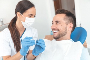Dentist and patient discussing the cost of Invisalign