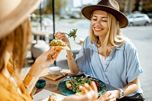 Two female friends enjoying a meal at a restaurant