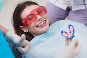 Smiling patient receiving fluoride treatment