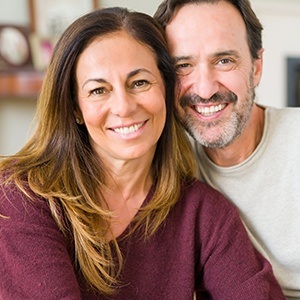 Man and woman smiling after restorative dentistry