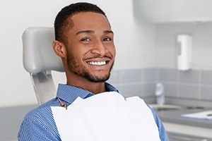 Man smiling after one visit dental restoration treatment