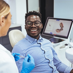 Happy patient speaking with his dentist