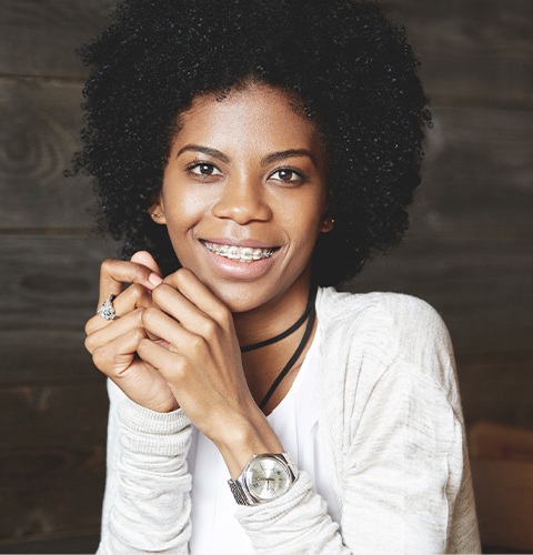 Woman with traditional orthodontics smiling