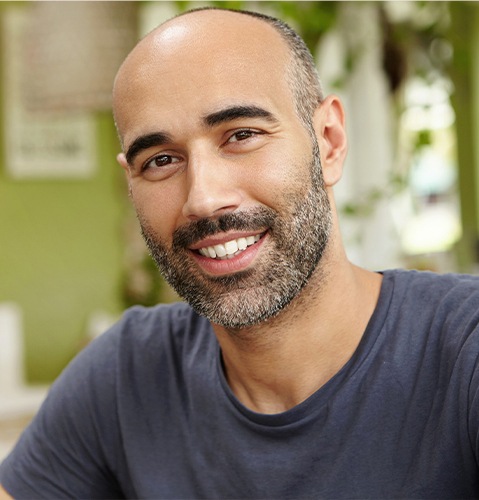 Man smiling in gray tee shirt