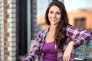 Young woman with bright smile after teeth whitening treatment