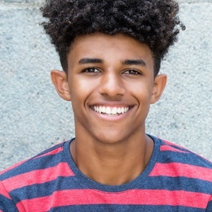 Young man with healthy smile after wisdom tooth extraction