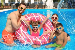 Smiling family having fun in pool