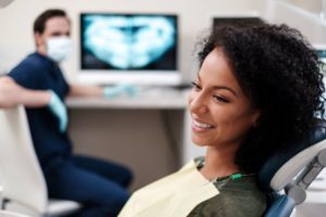 Smiling dental patient looking to her left