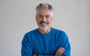 Happy, smiling senior man in blue sweater