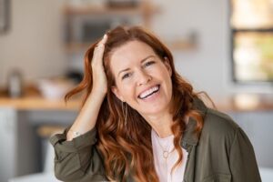 Portrait of confident middle-aged woman with beautiful teeth 